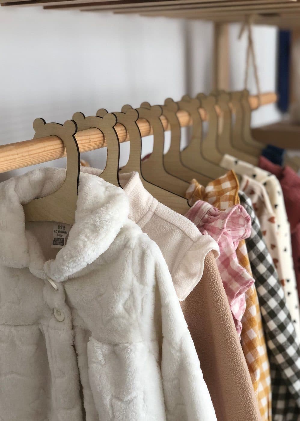 Children’s jackets and shirts hanging on a clothes rail