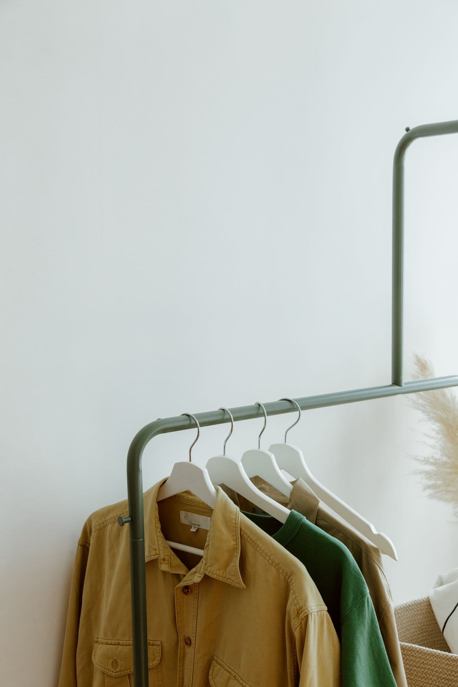 Shirts and knitwear hanging on a garment rack