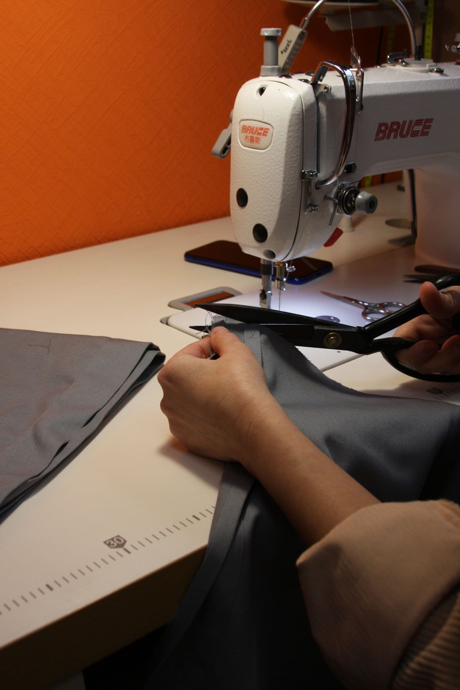 Fabric being cut with shears on a cutting table