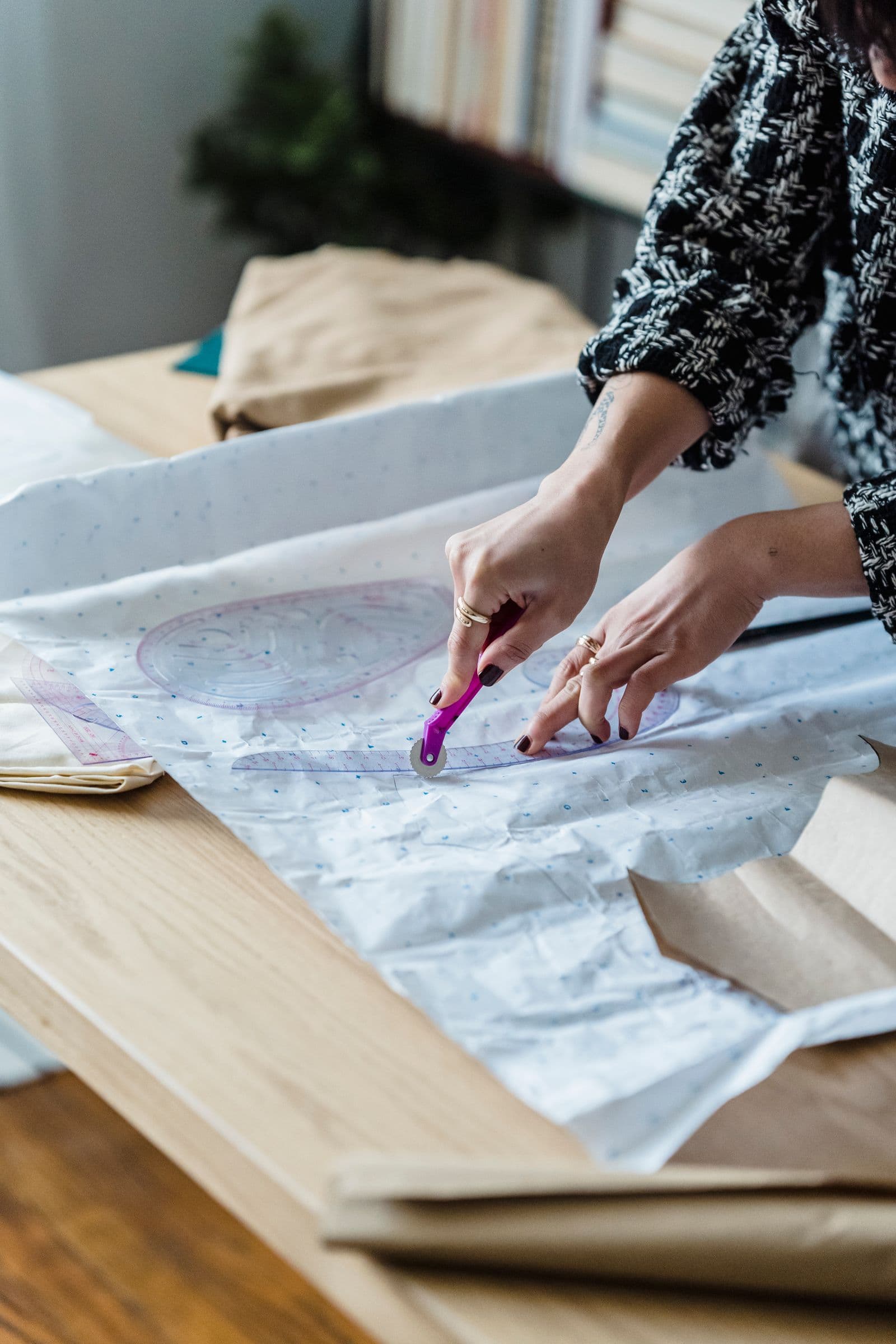 Tracing a garment pattern with rulers and a tracing wheel