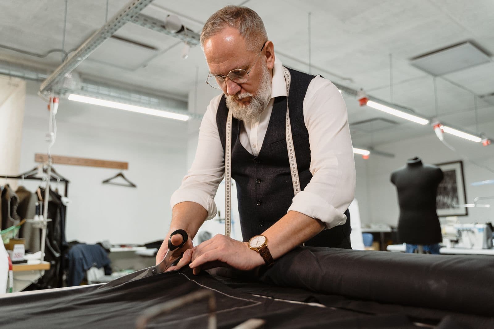 Cutting fabric on the table in a garment workshop