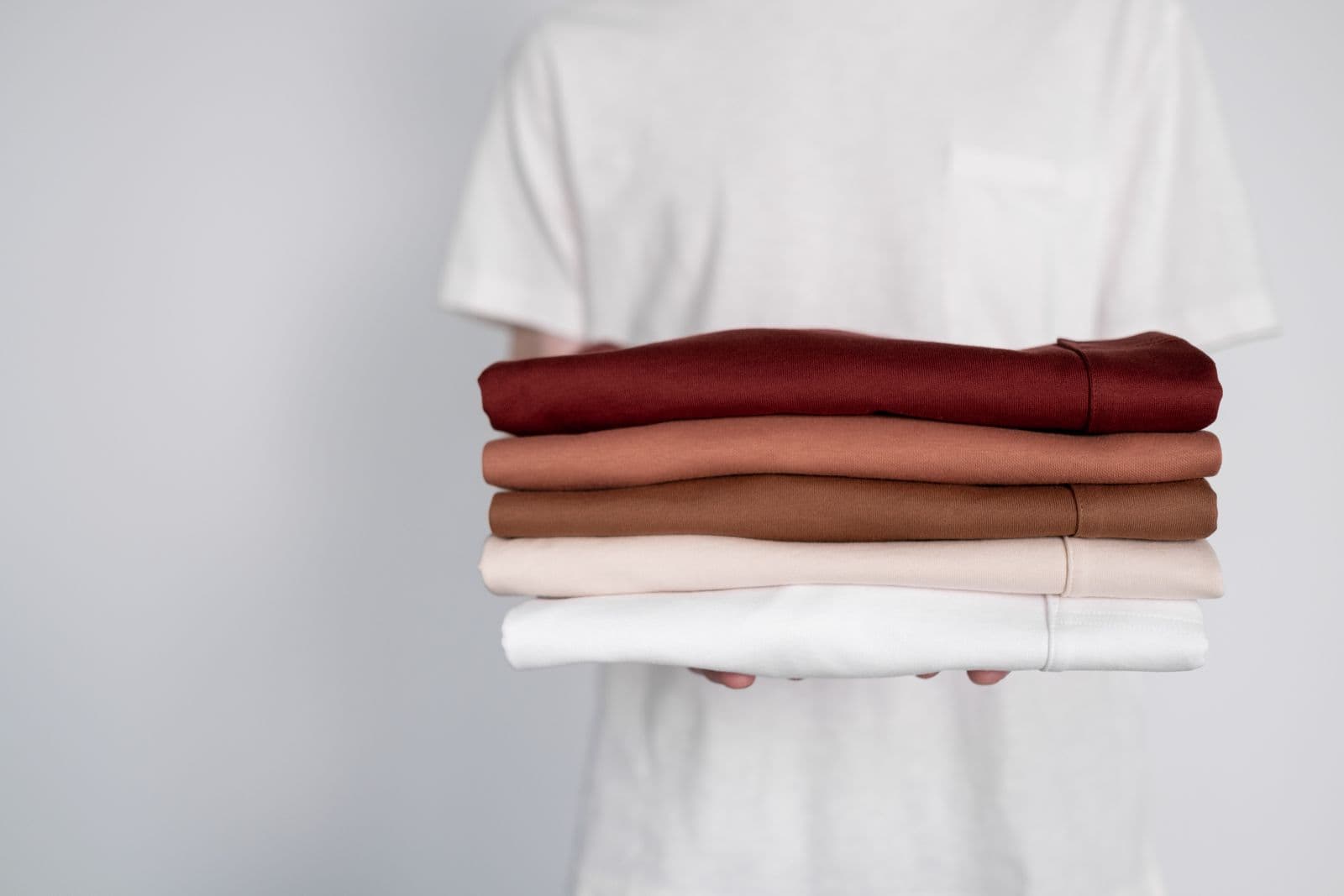 Stack of folded garments in earth tones